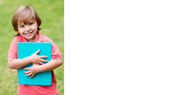 child holding a notebook